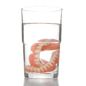 dentures in a glass of water